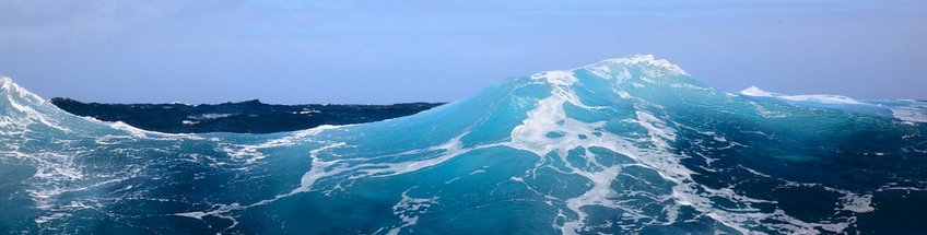 Coast GEm The picture shows the view of a large impressive wave in the North Sea in shades of blue with white foam