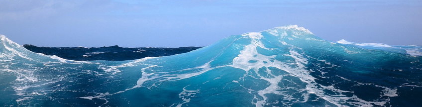 Coast GEm The picture shows the view of a large impressive wave in the North Sea in shades of blue with white foam